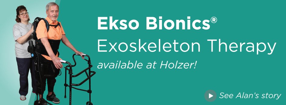 Ekso banner: Patient using the exoskeleton with help from physical therapist