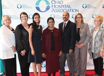 Renuka Kandula, MD (center) with family and fellow staff members