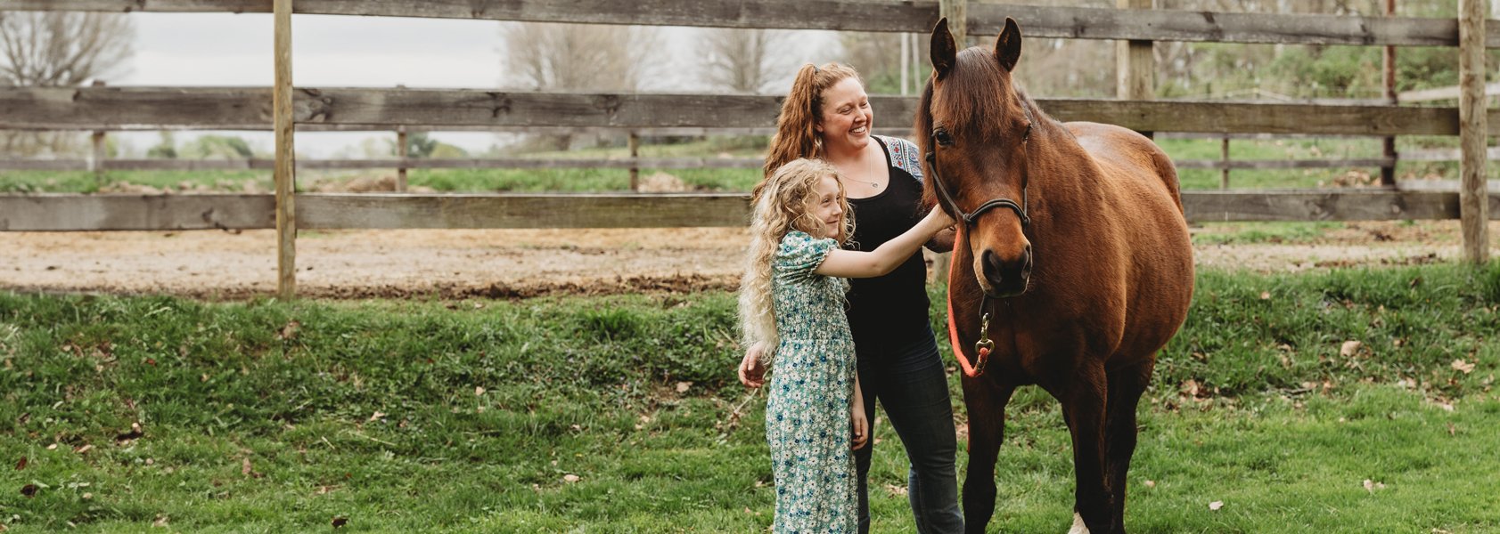 Banner: Dr. Maggard with her daughter taking care of horse